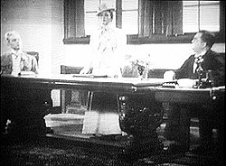 Polly presides over a meeting of her bank board - frame enlargement from the 1931 Pabst movie